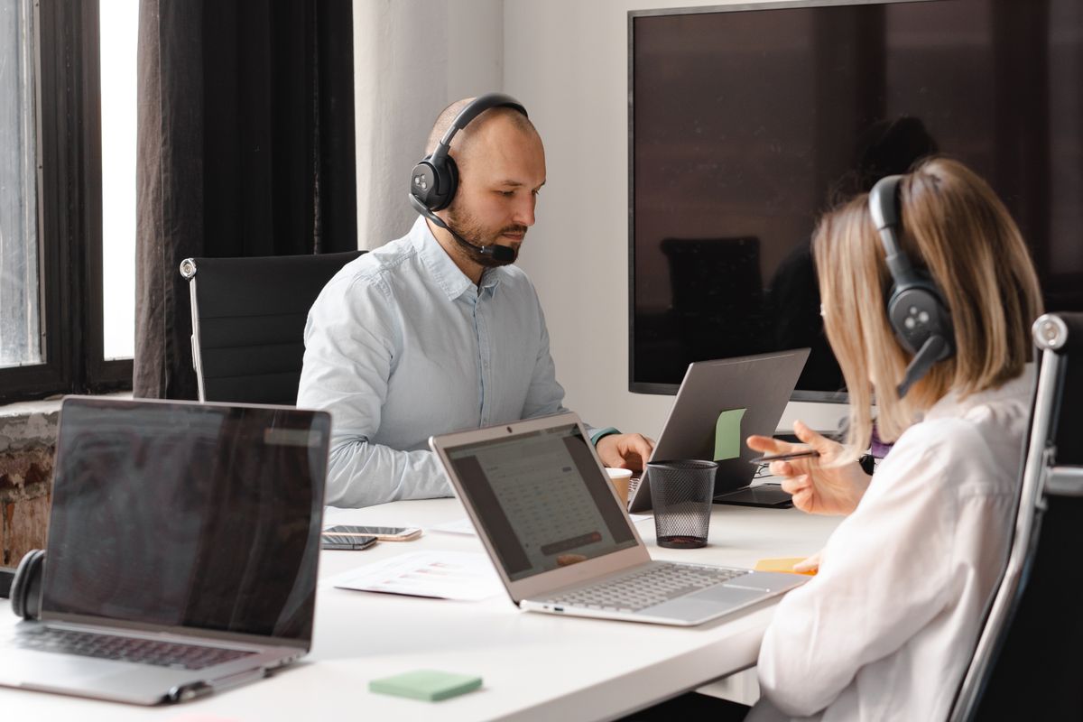 Customer support specialists assisting clients with headsets